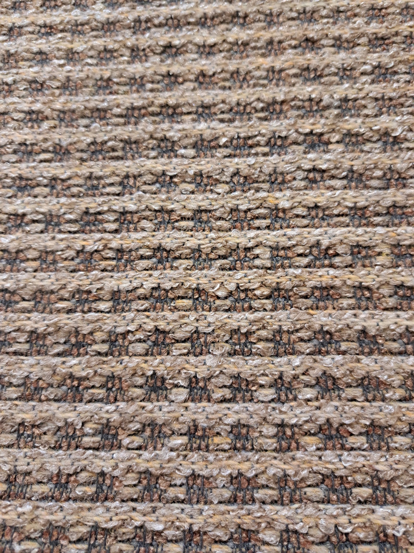 A close-up of the Boracay outdoor rug showing its textured surface with a muted color palette.