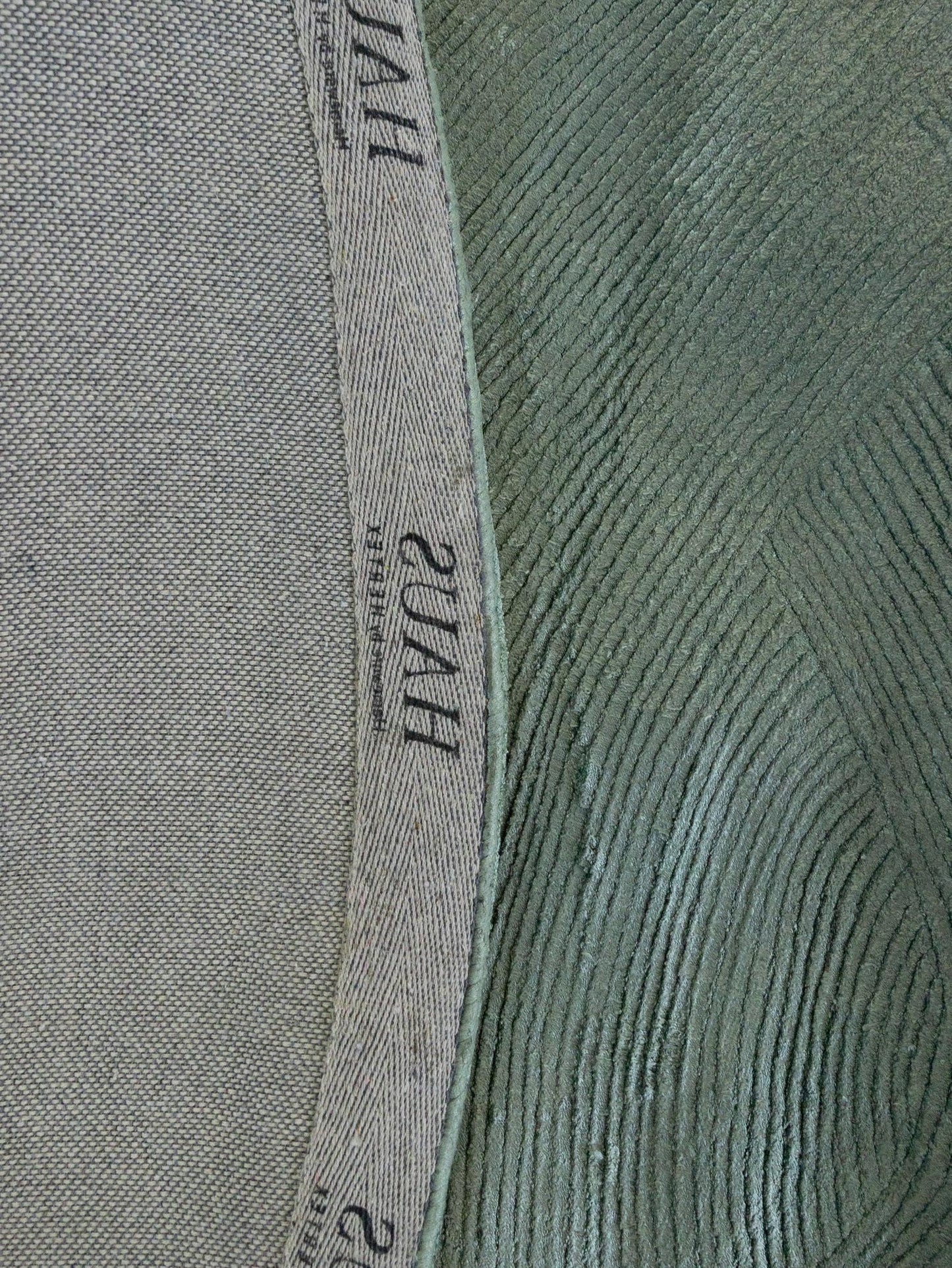 Close-up of a textured fabric with a brand label.