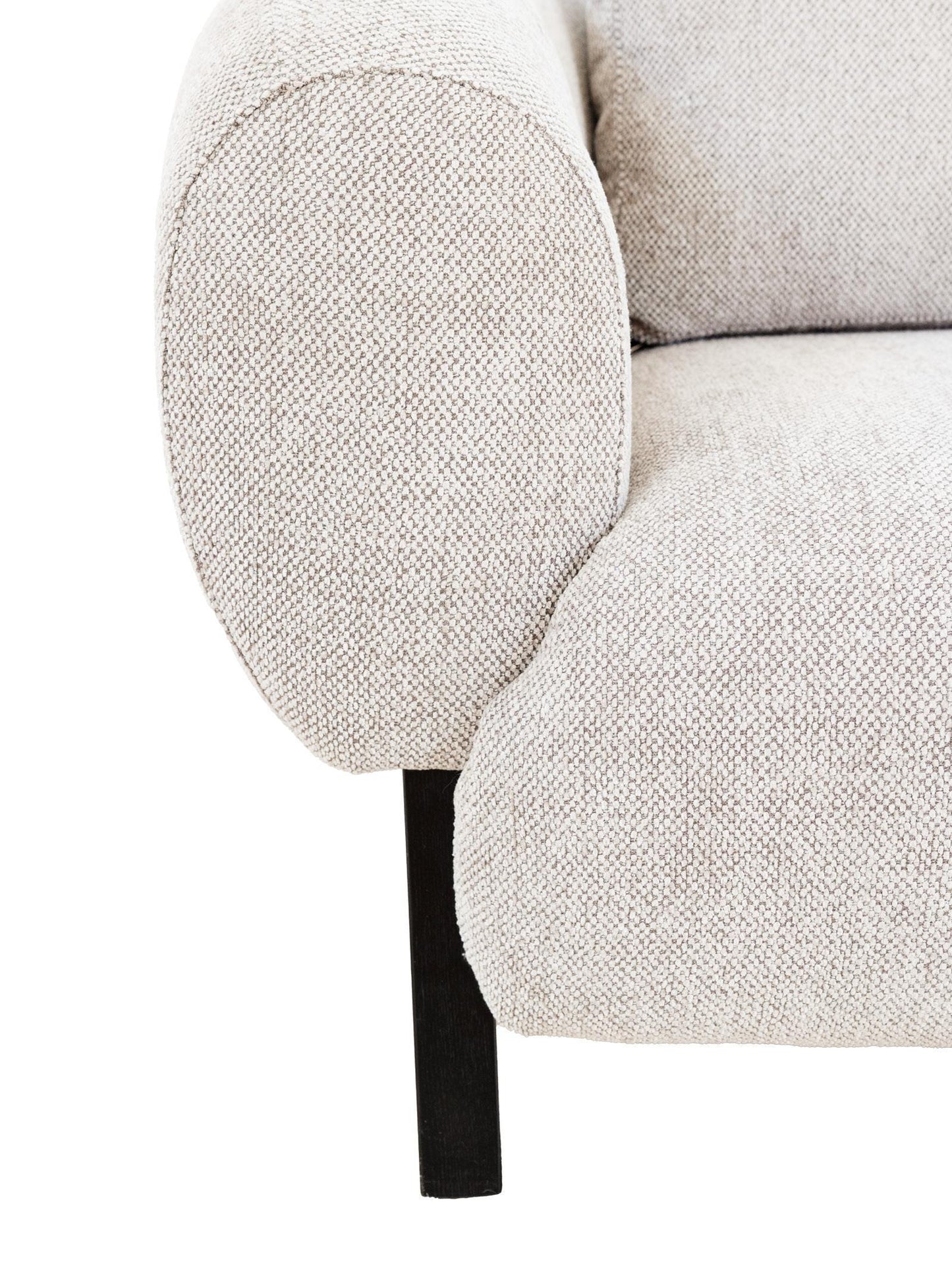 Close-up of a textured beige armchair with a white background