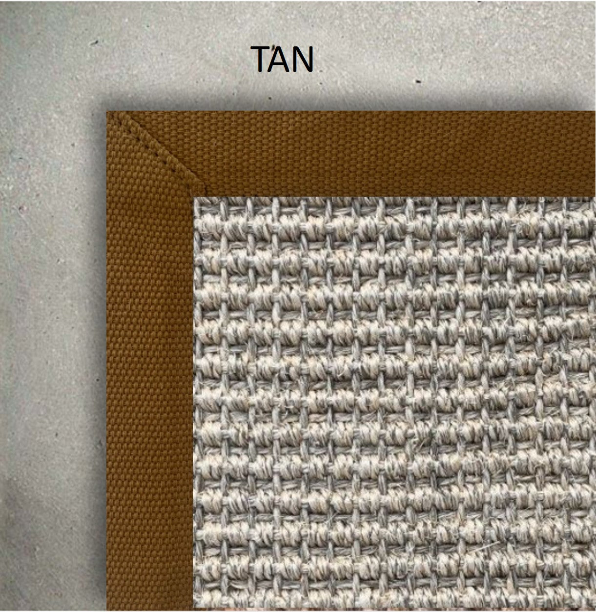 Close-up of a textured tan and gray rug corner on a concrete floor.