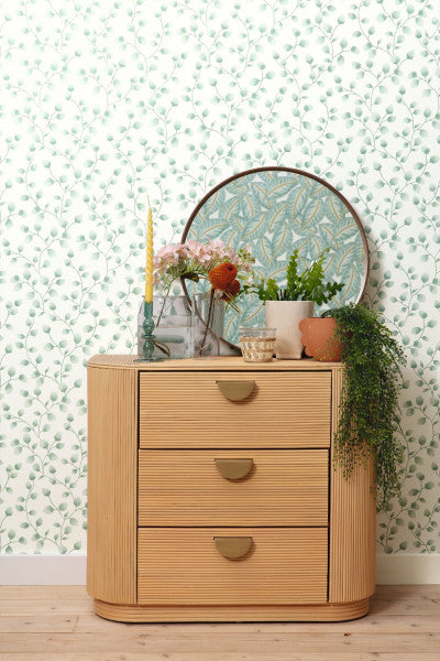 A wallpaper with a green background featuring a pattern of white eucalyptus leaves.