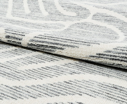 Close-up of a textured white and gray rug