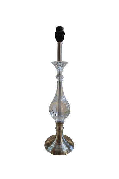 Decorative lamp with a clear glass shade and metal base on a white background