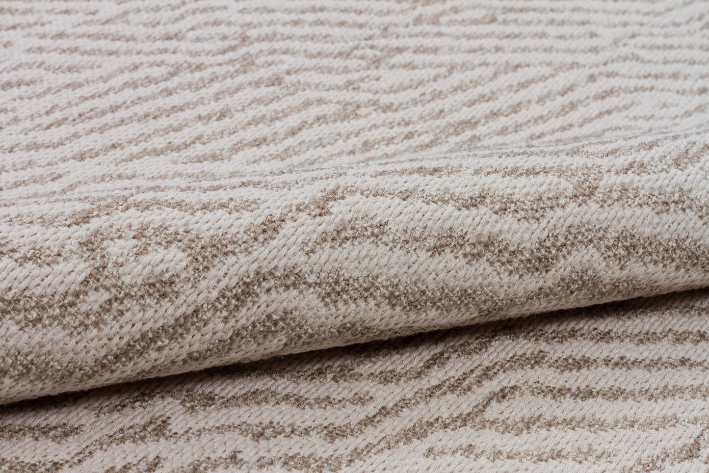 Close-up of textured beige fabric with a subtle pattern