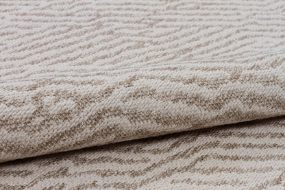 Close-up of textured beige fabric with a subtle pattern