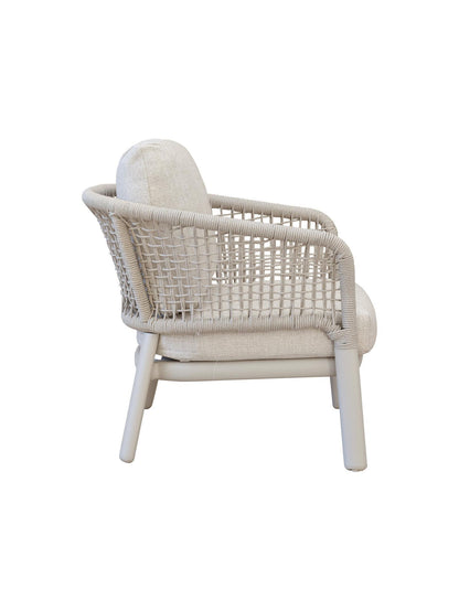 Wicker armchair with white cushion on a white background