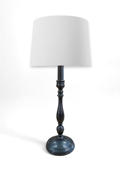 Table lamp with a white shade and dark blue base on a white background