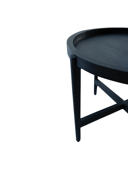 Black round side table on a white background