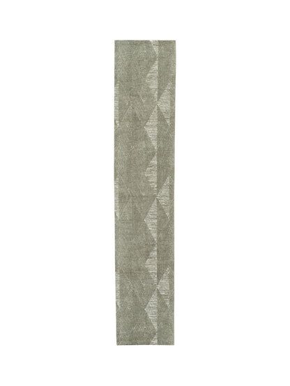 Long, narrow runner rug with geometric pattern on a white background