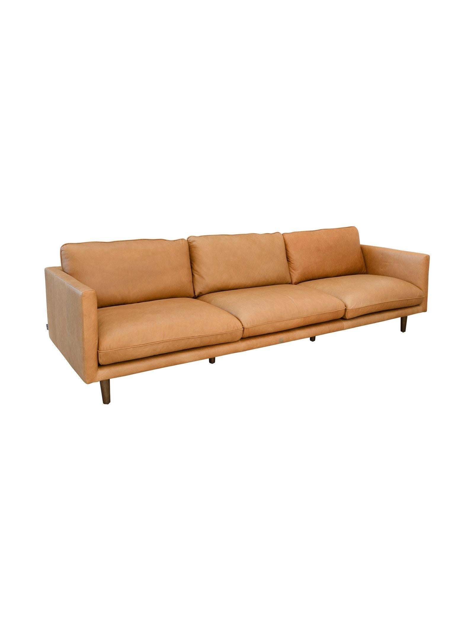 Tan leather sofa on a white background