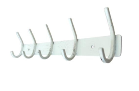 White wall-mounted coat rack with multiple hooks on a white background