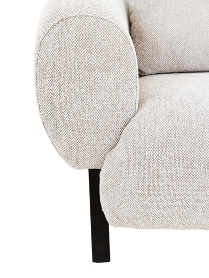 Close-up of a textured beige armchair with a white background