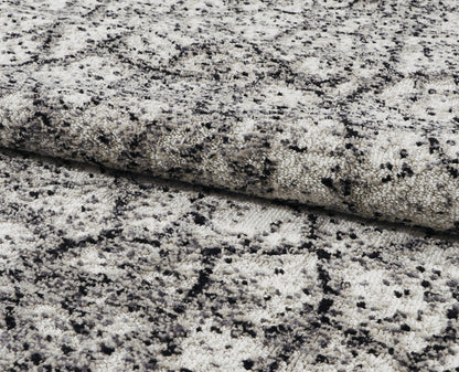 Close-up of gray and black speckled stone rug