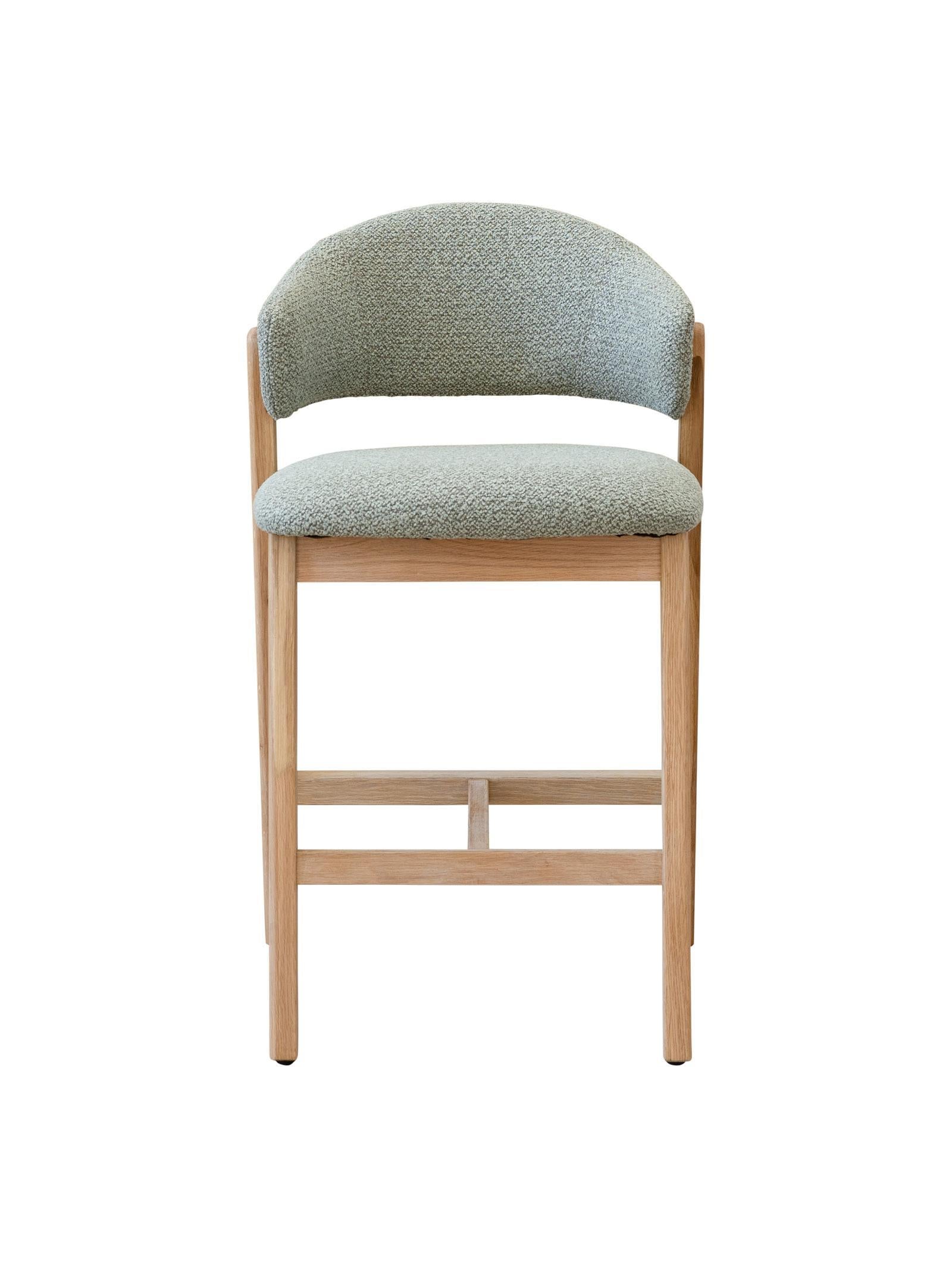 Counter stool with Sage cushioned seat and backrest on a white background