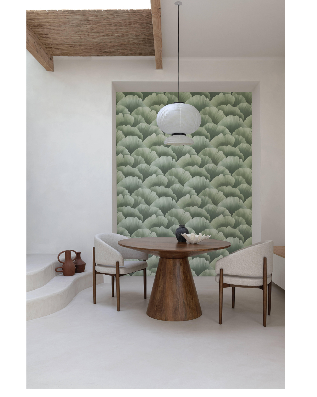 Dining room with a wooden table and chairs against a green forest wallpaper.