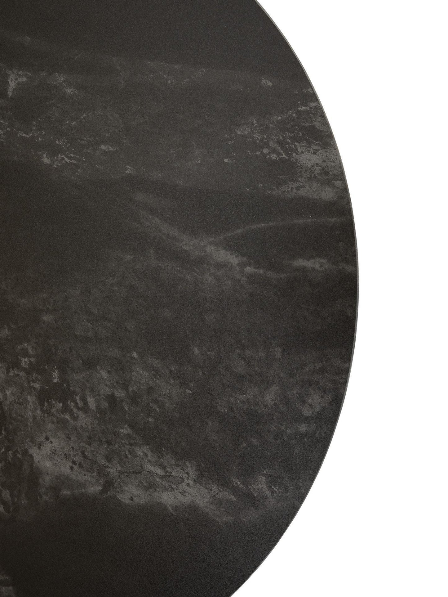 Round black marble table top with a textured surface