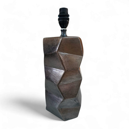 Geometrically shaped resin lamp base on a white background