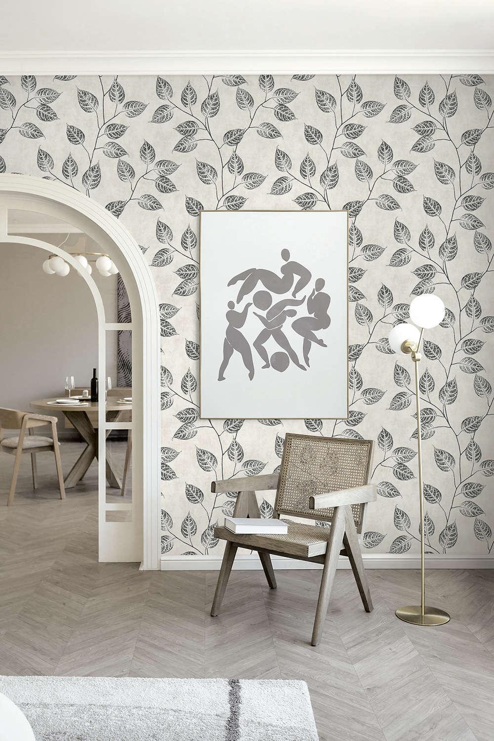 Modern interior with leaf-patterned wallpaper, a chair, and a floor lamp.