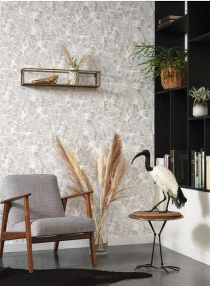Modern interior with a gray armchair, decorative plant, and wall art. A wallpaper with a floral pattern featuring large leaves in a muted color palette, with a subtle shimmering overprint.