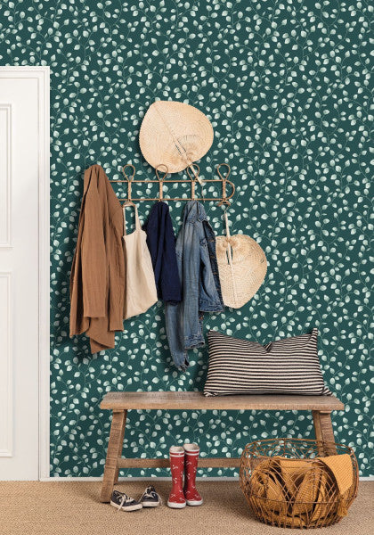A wallpaper with a green background featuring a pattern of white eucalyptus leaves.