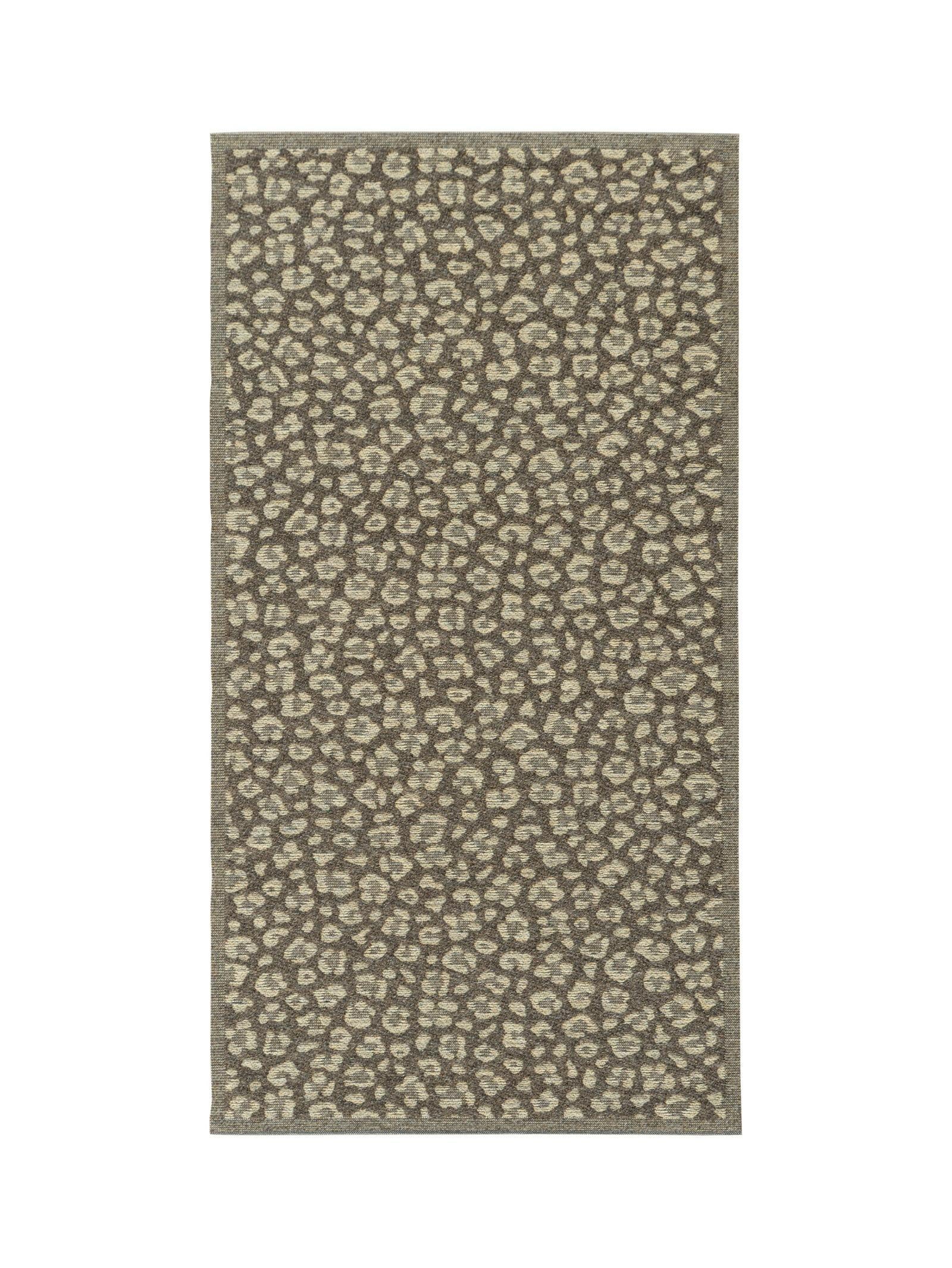 Rug with a leopard print pattern on a white background