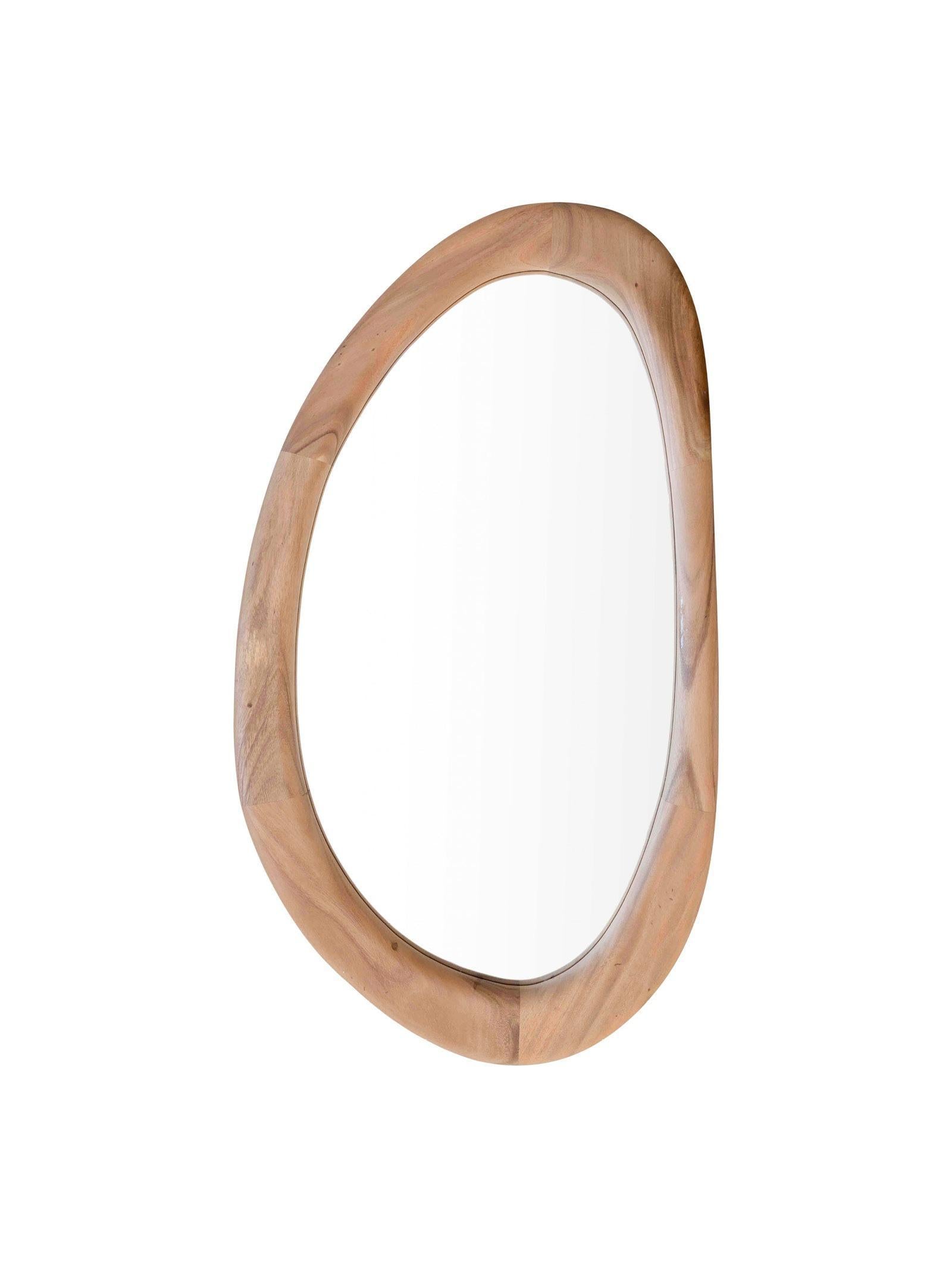 Wooden-framed oval mirror on a white background