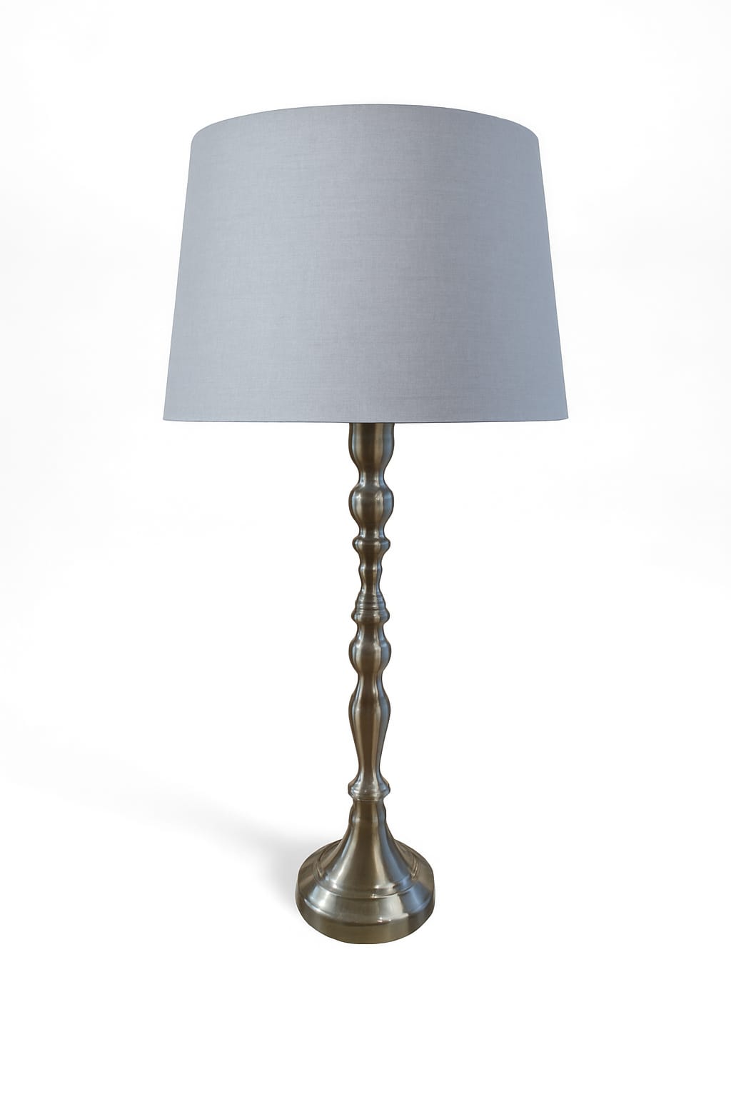 Table lamp with a gray shade and metallic base on a white background