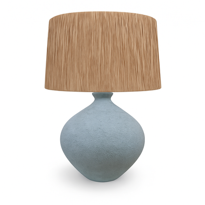 Table lamp with a textured blue base and a brown rattan shade on a white background