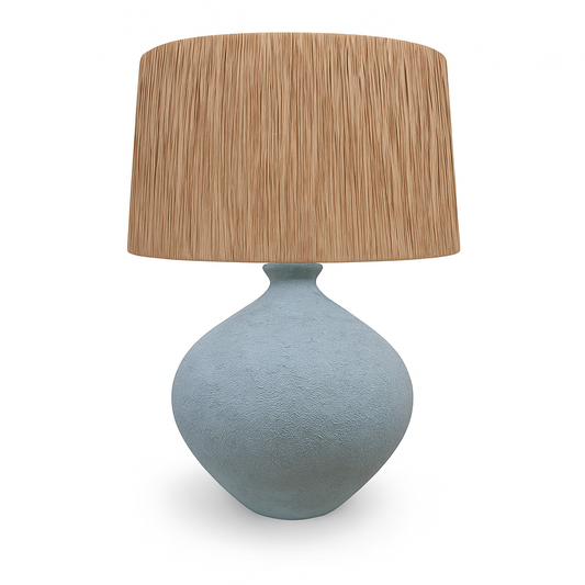 Table lamp with a textured blue base and a brown rattan shade on a white background