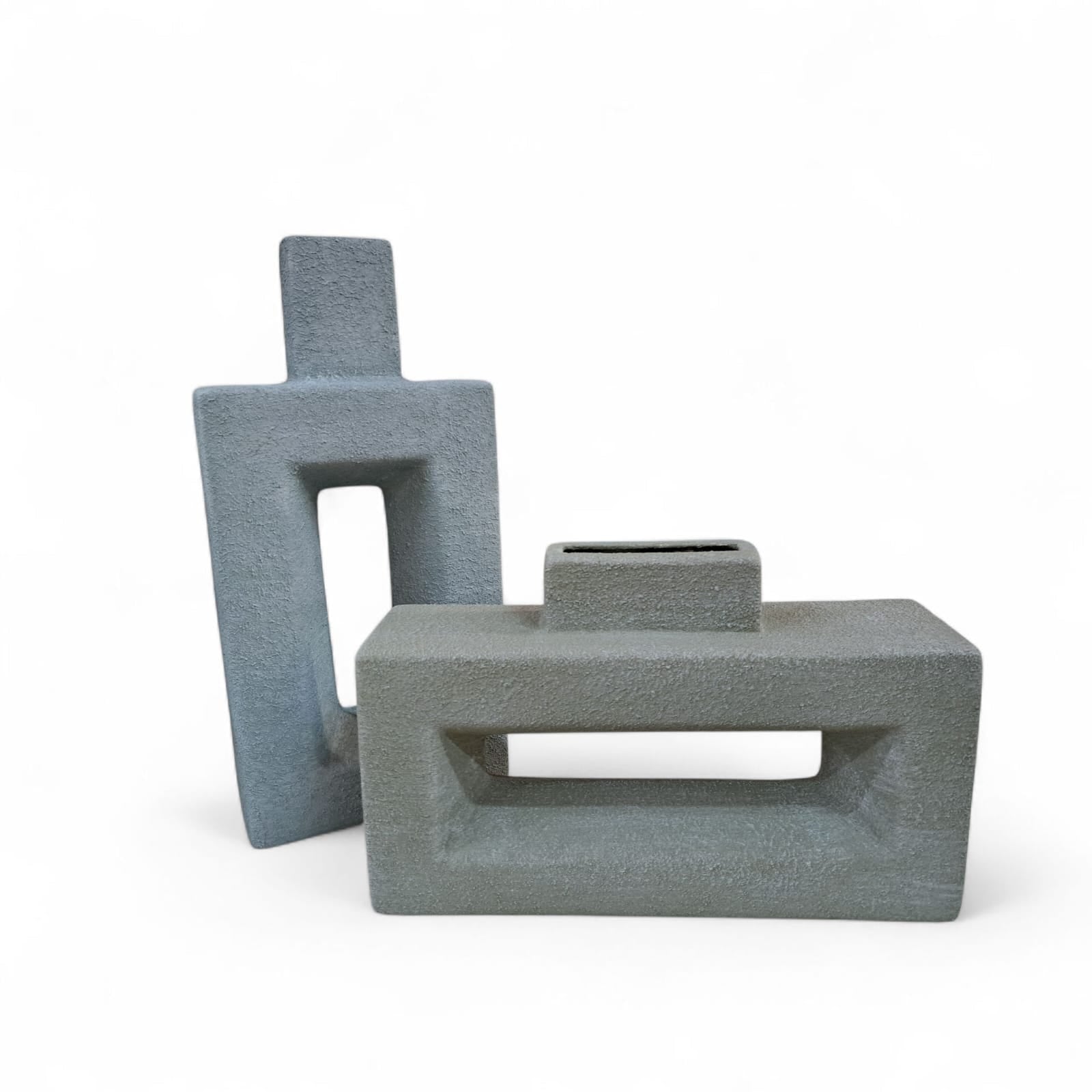 Two gray geometric ceramic vases on a white background